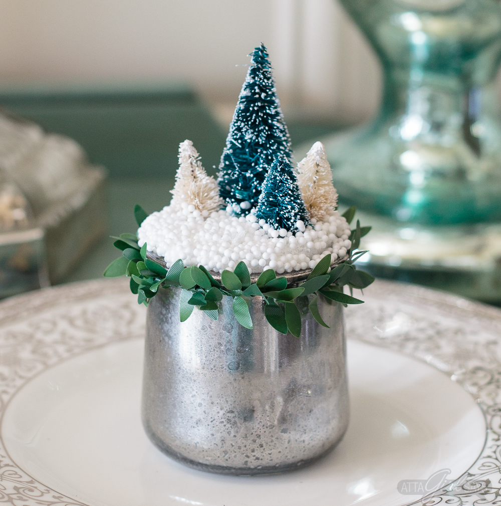 Turn glass yogurt jars into stunning sea glass and mercury glass votives. Add bottlebrush trees, greenery, tinsel and faux snow and use them as part of your Christmas decor. Click for step-by-step instructions and a complete supply list for making them. Plus check out the other ideas for repurposing jars and decorating with jars.