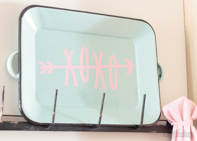 Dress up your coffee mug wall rack with simple Valentine's Day decor, including a "Gossip Girl" inspired quote you can make with your Cricut. Enamel coffee mugs, miniature boxwood wreaths and heart-shaped plates! Swoon. Click for sources to recreate this look! #mugrack #valentinesday #gossipgirl #xoxo #farmhouse #aquaandpink #mugrackmonday #valentinesdecor #cricutmade #cricutmaker #cricutexploreair #quotes