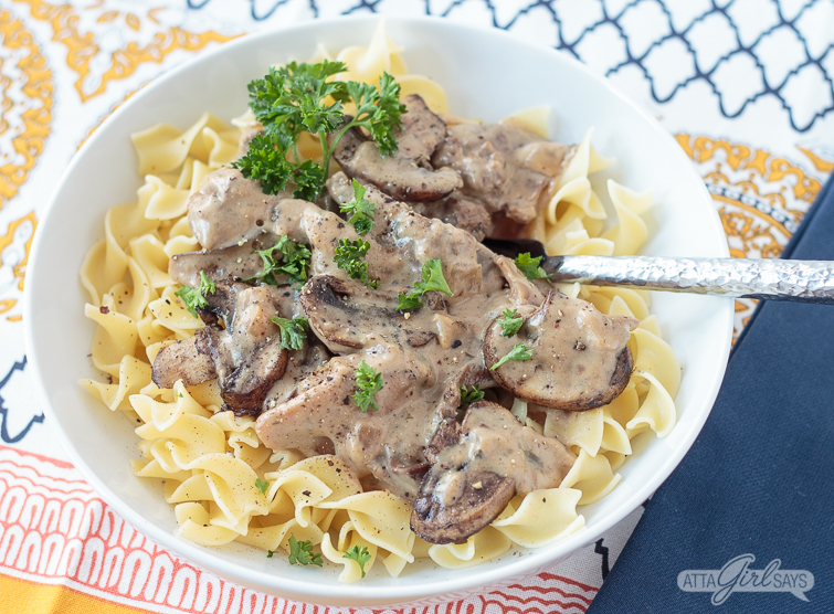 bowl of beef stroganoff over noodles