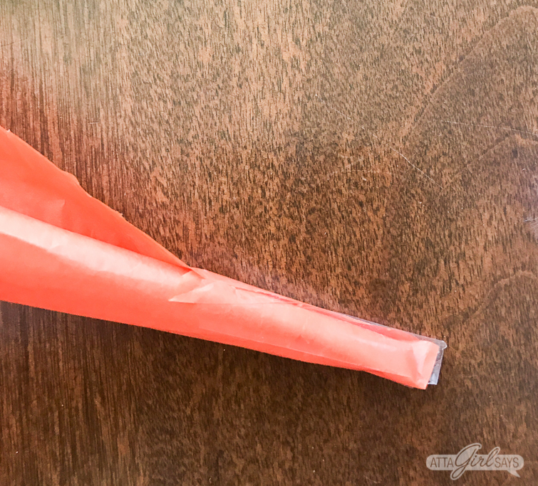 These tissue paper carrots hide a tasty surprise inside. Fill them with miniature chocolate eggs, jelly beans, M&M's or another favorite Easter candy. Click for step-by-step instructions, plus a supply list to make this adorable, edible Easter basket craft. #Easter #tissuepaper #carrots #eastercrafts