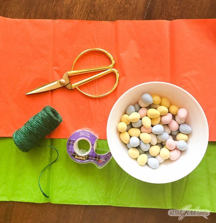 These tissue paper carrots hide a tasty surprise inside. Fill them with miniature chocolate eggs, jelly beans, M&M's or another favorite Easter candy. Click for step-by-step instructions, plus a supply list to make this adorable, edible Easter basket craft. #Easter #tissuepaper #carrots #eastercrafts