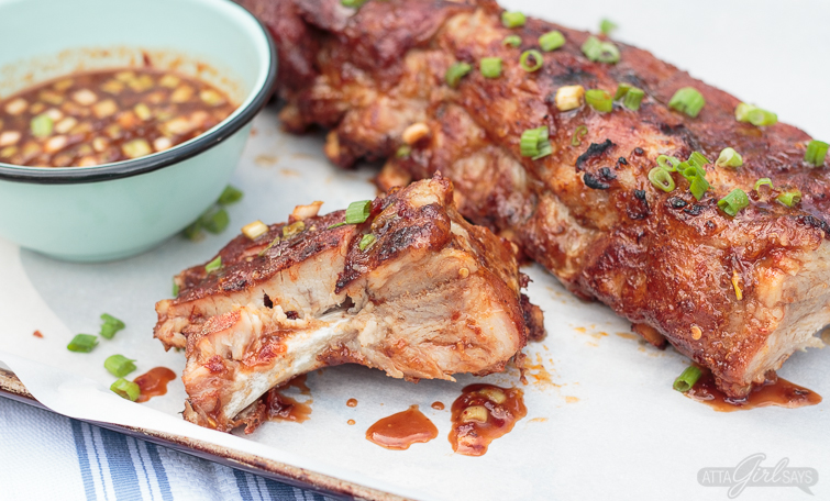 These Asian sweet & spicy grilled baby back ribs are going to be the star of your next cookout! Seasoned with a delicious homemade spice rub and slow cooked on the grill until they're fall-off-the-bone tender, the ribs are finished with a maple chili garlic sauce. You'll feel like a champion pitmaster every time you serve these! #ad #GetGrillingAmerica #ribs #grilledribs