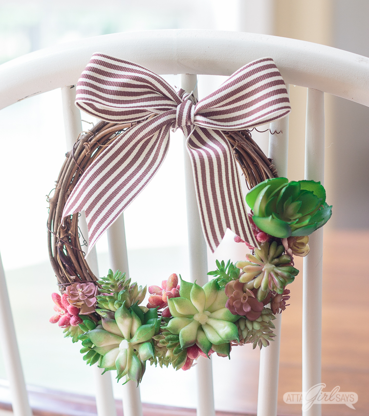 Learn how to make a realistic looking DIY faux succulent wreath for your summer decorating. Hang them on the backs of your dining chairs, on lampshades, on cabinet doors or anywhere else you like. They're great for summer and add a nice natural touch to your home decor. #succulents #succulentwreath #tablescape #decoratingideas #decoratingwithplants