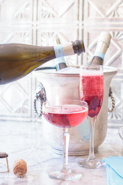 Pouring Prosecco into a champagne flute to make a blooming hibiscus cocktail. No special occasion necessary. Invite your best gal pals over for brunch and laughs and serve up these delicious pretty pink hibiscus cocktails featuring La Marca Prosecco. Learn how to make infused hibiscus vodka and hibiscus simple syrup to make recipes to make three different versions of the hibiscus Prosecco cocktail, plus ideas for throwing a fabulous brunch. #ad #CelebratorySips #CelebrateWithLaMarca