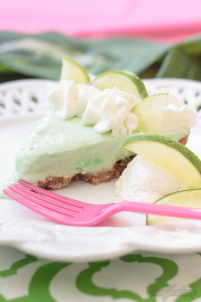 Looking for a refreshing and delicious dessert to serve this summer? Try this frozen margarita pie with a salted coconut graham cracker crust. It's made with ice cream, lime sherbet and margarita mix. If you like, add a shot of tequila to make an adults-only version. #margarita #icecreampie #margarita pie #tequilapie #nobakedessert #dessert #dessertrecipe #summerdessert #springsoiree #springsoireebloghop