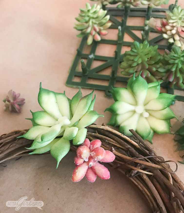 Learn how to make a realistic looking DIY faux succulent wreath for your summer decorating. Hang them on the backs of your dining chairs, on lampshades, on cabinet doors or anywhere else you like. They're great for summer and add a nice natural touch to your home decor. #succulents #succulentwreath #tablescape #decoratingideas #decoratingwithplants