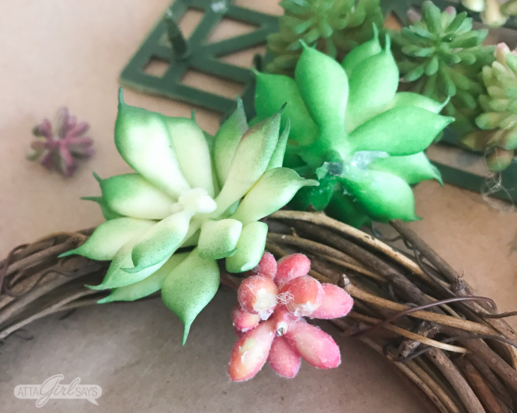 Learn how to make a realistic looking DIY faux succulent wreath for your summer decorating. Hang them on the backs of your dining chairs, on lampshades, on cabinet doors or anywhere else you like. They're great for summer and add a nice natural touch to your home decor. #succulents #succulentwreath #tablescape #decoratingideas #decoratingwithplants