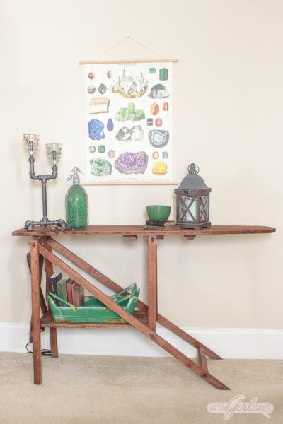 Turn an antique wooden ironing board into a console table with storage. This is an easy DIY project for beginners; a drill is the only tool you'll need. #upcycle #furniturebuilding #ironingboard #woodironingboard