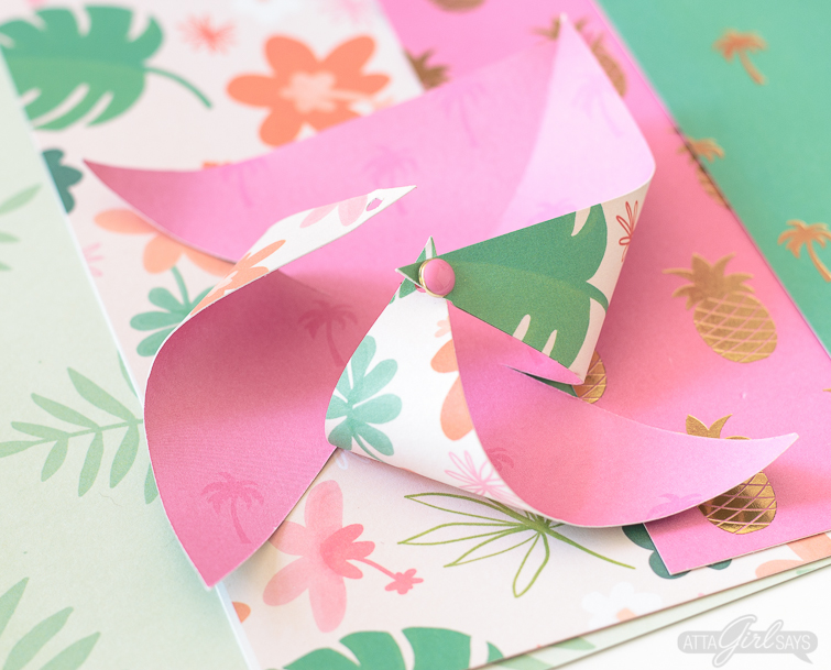 Need to add a festive touch to any occasion? Grab some pretty patterned scrapbook paper and I'll show you how to make pinwheels. They're so easy to make, even kids can help! Use your homemade pinwheels for party banners, cupcake toppers, centerpieces and more. #papercrafts #pinwheels #scrapbookpaper
