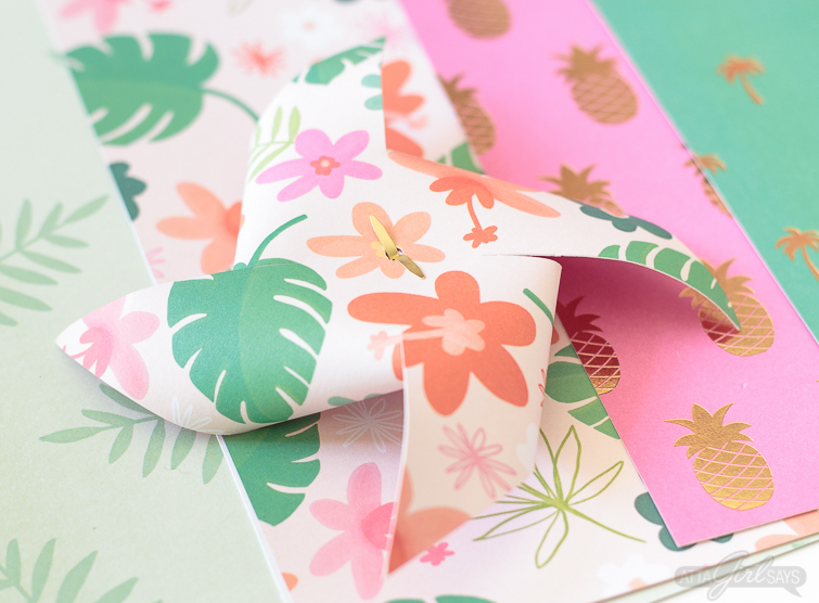 Need to add a festive touch to any occasion? Grab some pretty patterned scrapbook paper and I'll show you how to make pinwheels. They're so easy to make, even kids can help! Use your homemade pinwheels for party banners, cupcake toppers, centerpieces and more. #papercrafts #pinwheels #scrapbookpaper