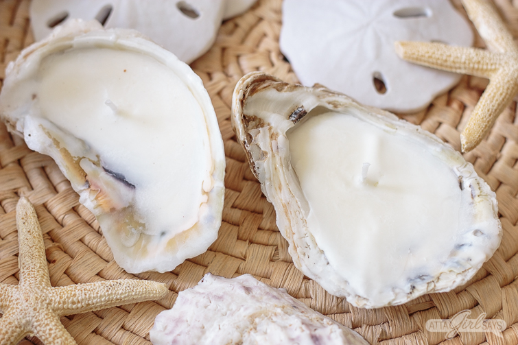 Homemade oyster sea shell candles on a woven seagrass mat