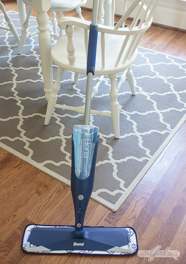 Bona Spray Mop leaning against a white kitchen chair