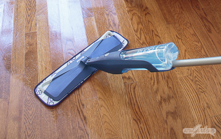 closeup photo of a Bona spray mop cleaning oak hardwood floors