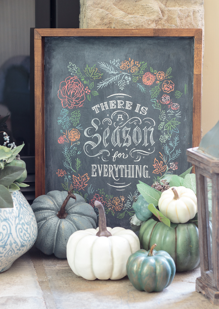 chalkboard sign "There is a Season for Everything" on a heart surrounded by blue, white and aqua pumpkins