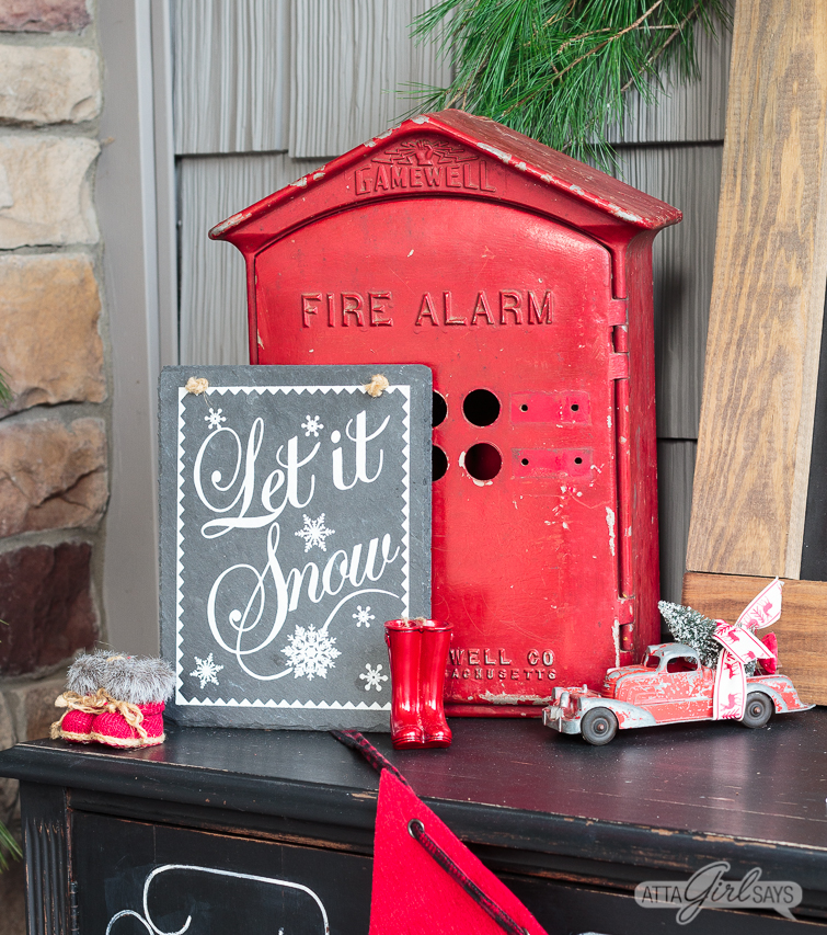 vintage red fire alarm box used on a front porch as Christmas decor