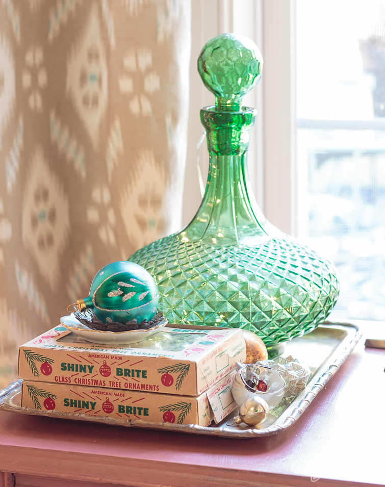 Shiny Brite ornament boxes and a green glass decanter