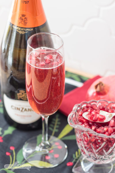 festive pomegranate mimosa made with prosecco