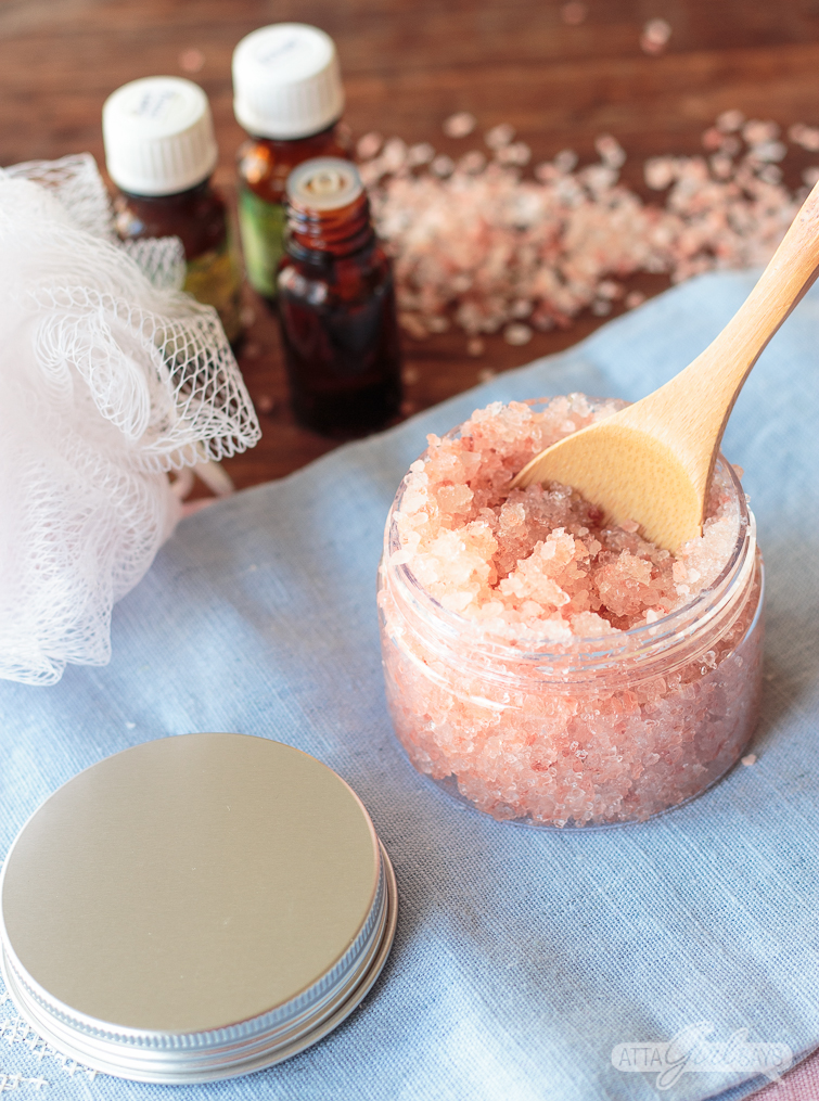 essential oil bottles and homemade pink Himalayan salt scrub