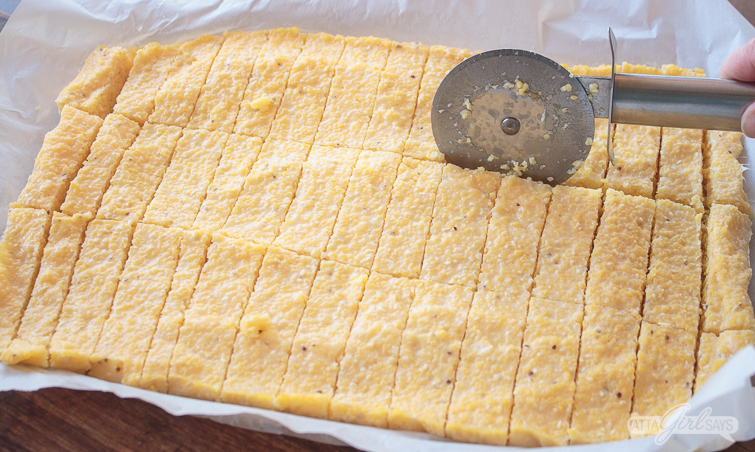 cutting leftover grits into grit fries with a pizza cutter