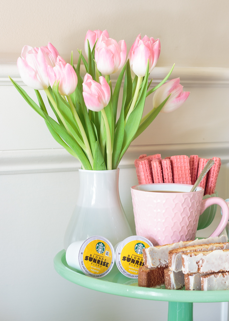 bouquet of pink tulips on a green cake stand with coffee bar fixings