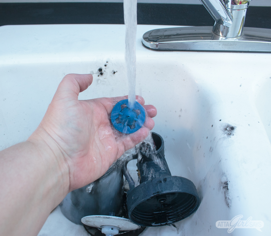 cleaning a Wagner paint sprayer in a sink