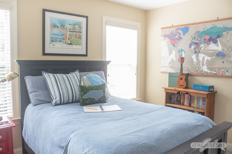 tween bedroom with black Pottery Barn style bed and blue comforter