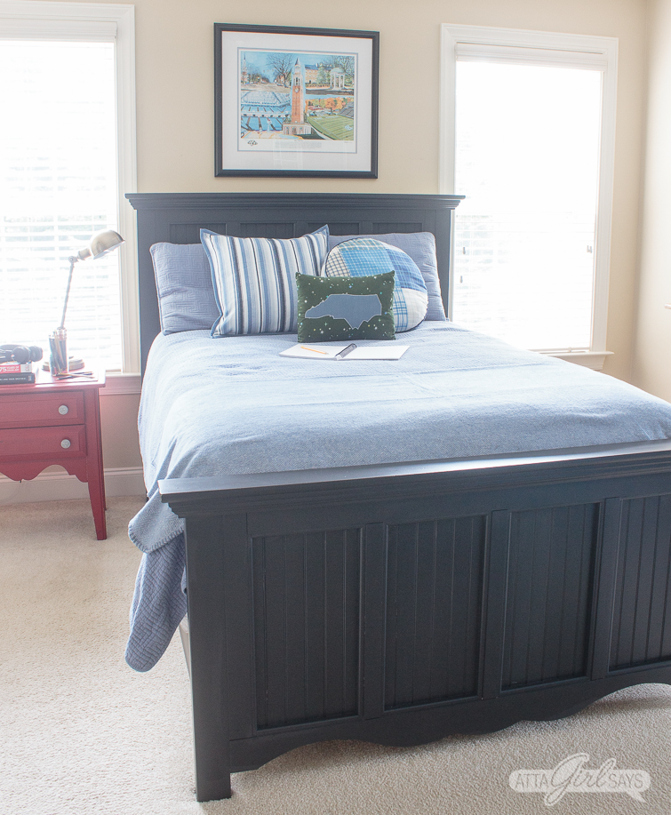 tween bedroom with black Pottery Barn style bed and blue comforter