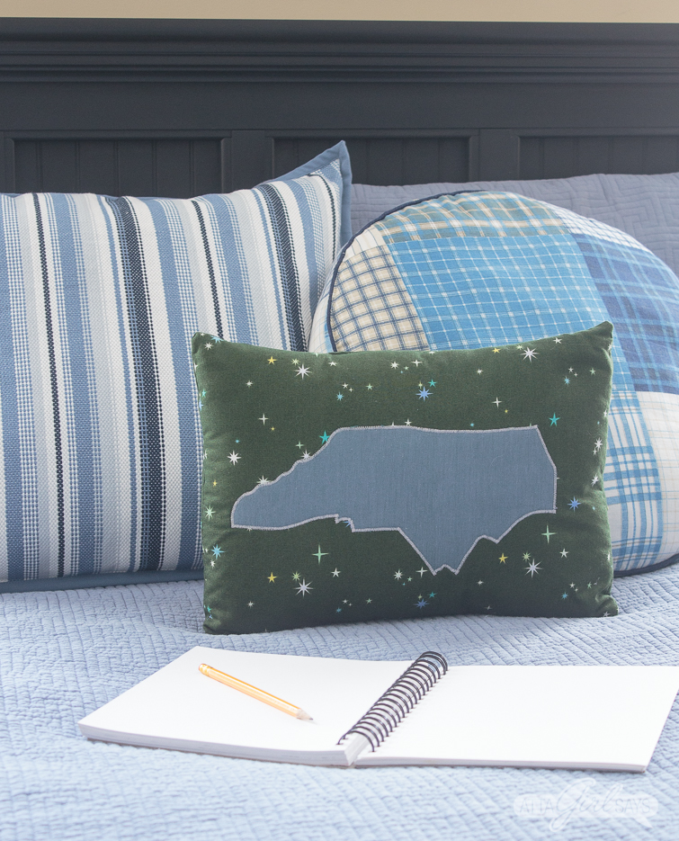 North Carolina pillow and sketch pad on a tween boy's bed