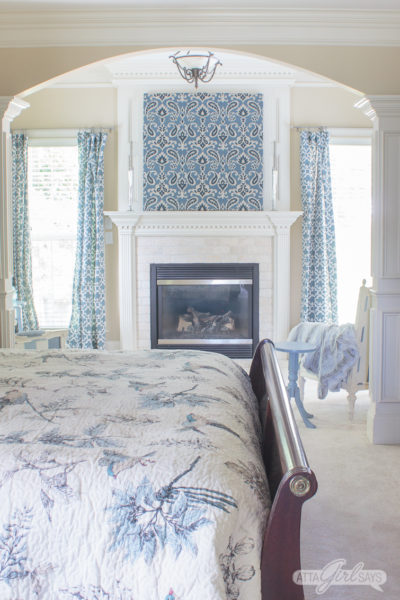 sitting room with a fireplace with blue artwork over the fireplace