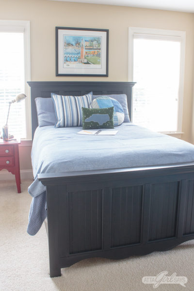 tween bedroom with black Pottery Barn style bed and blue comforter