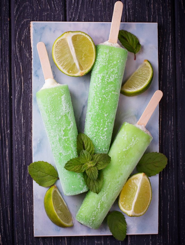 lime margarita popsicles surrounded by lime slices
