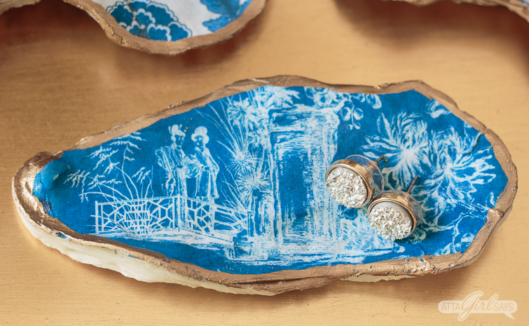blue and white chinoiserie design on an oyster shell