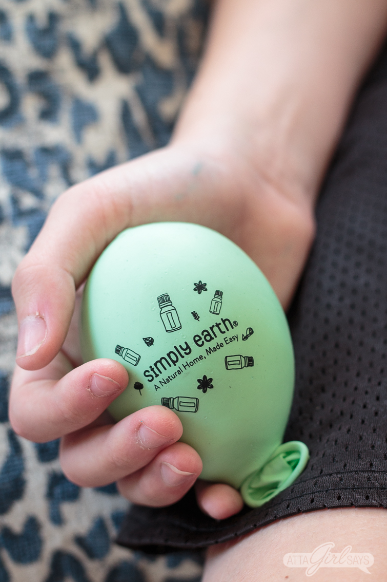 boy holding a DIY stress ball for kids made from a balloon