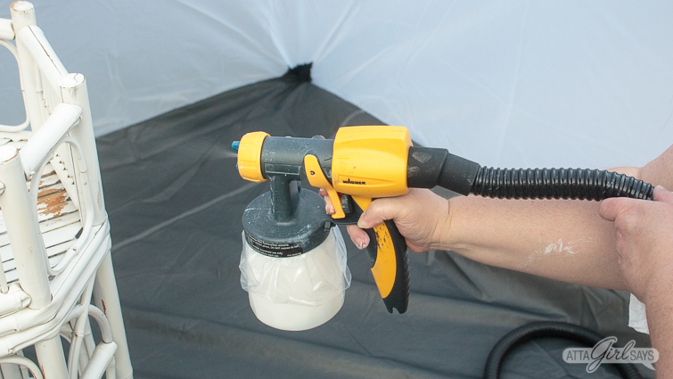using a paint sprayer to paint a bamboo plant stand