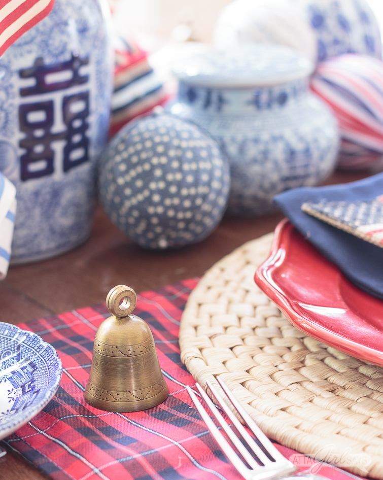brass bell place card holder on a patriotic table