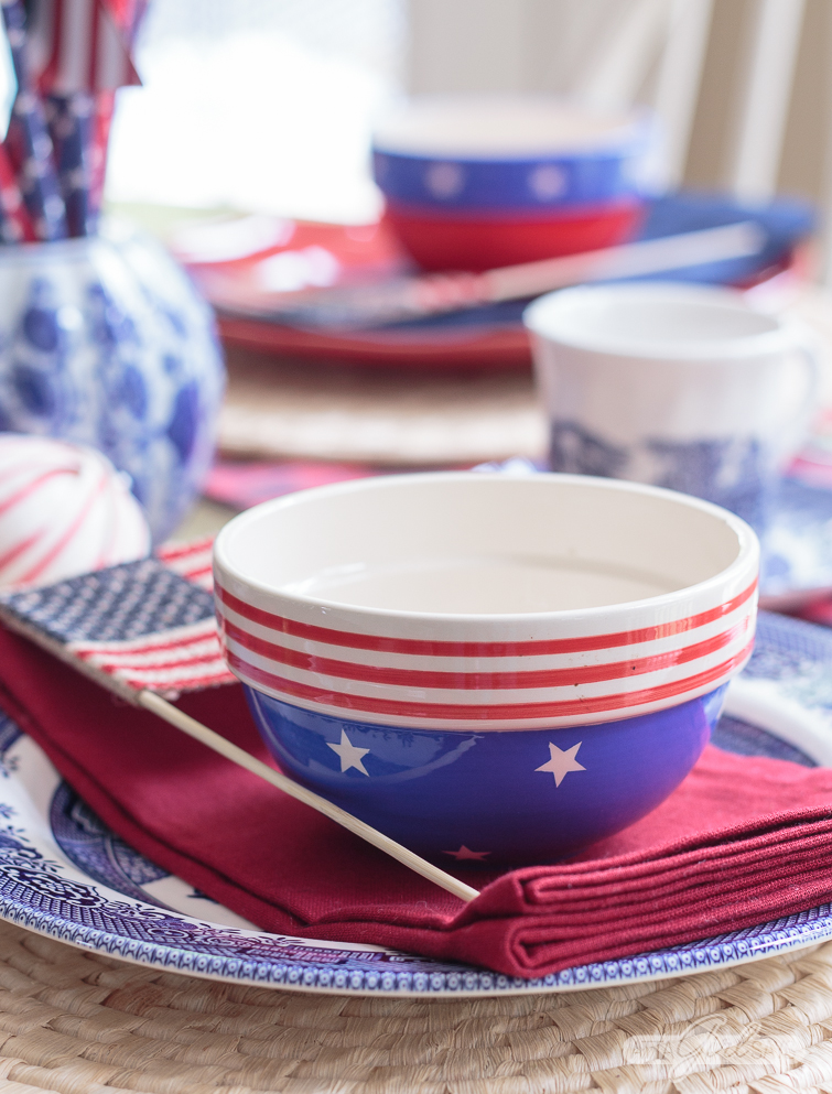 patriotic tablescape with blue and white china and ginger jars mixed with plaid