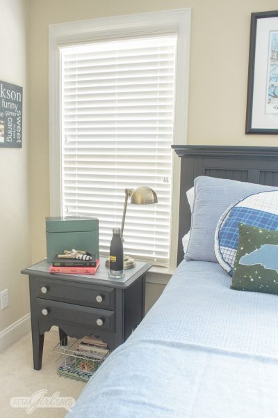 boy's bedroom with dark gray bed and nightstand and blue bedding
