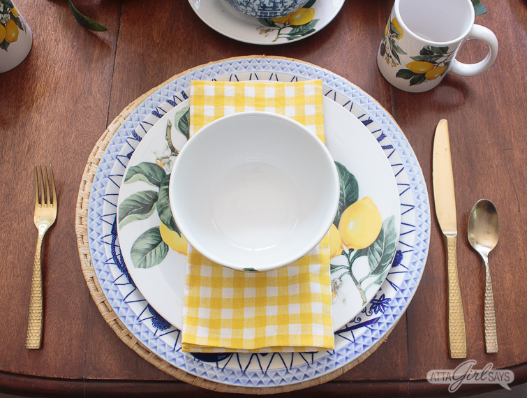 blue and lemon yellow place setting with a gingham napkin