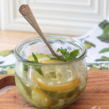 Weck jar of freezer pickles garnished with mint leaves
