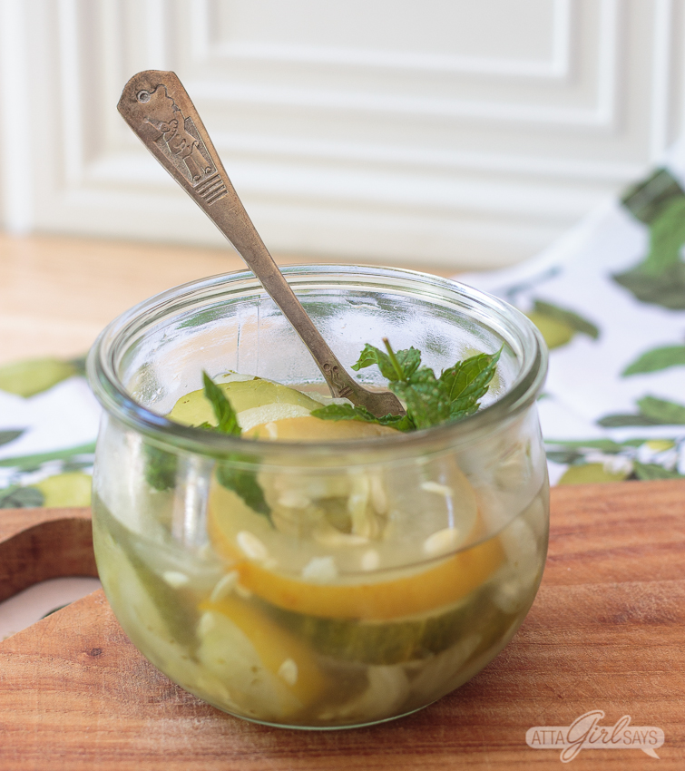 Weck jar of freezer pickles garnished with mint leaves