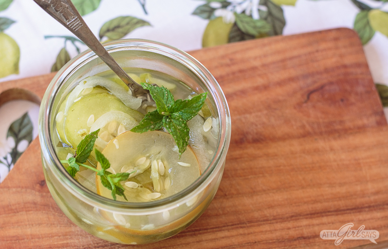 Weck jar of freezer pickles garnished with mint leaves