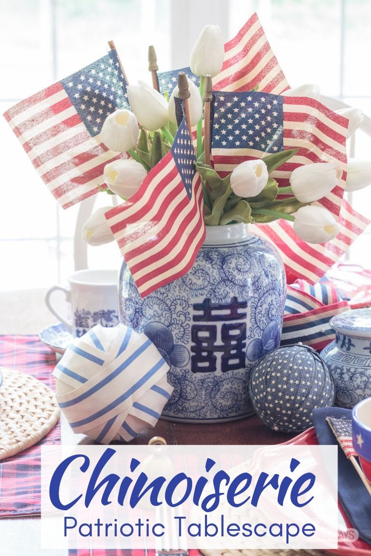 flags and tulips in a Chinese blue and white double happiness jar with other patriotic 4th of July table decorations