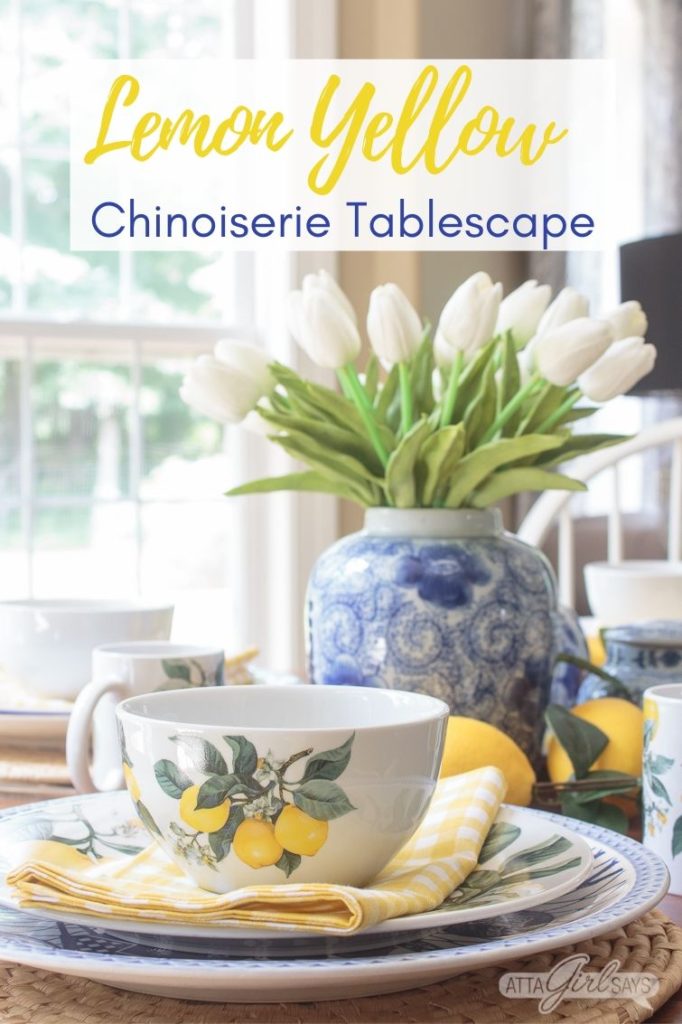 yellow lemon bowl on a dining table with a blue and white vase of tulips in the background
