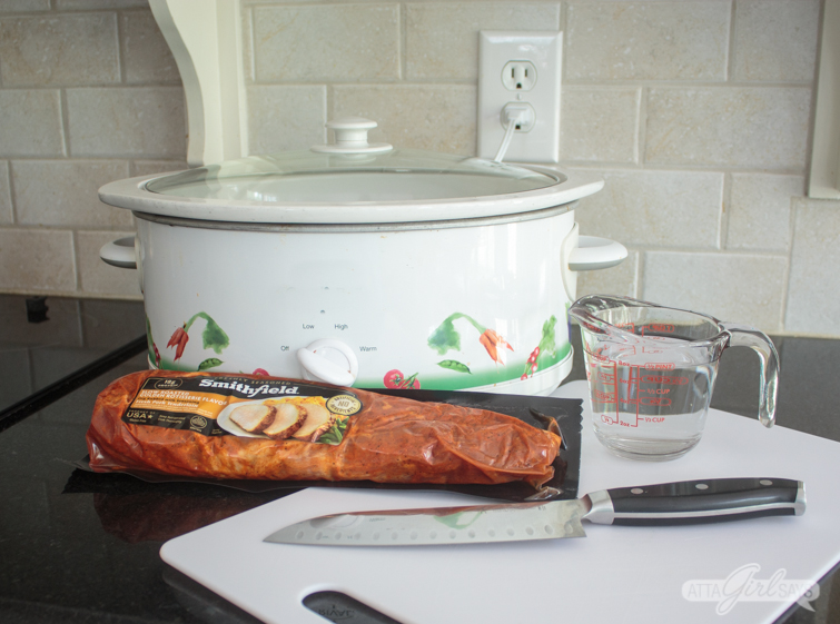 pork tenderloin being prepared to go into a slow cooker