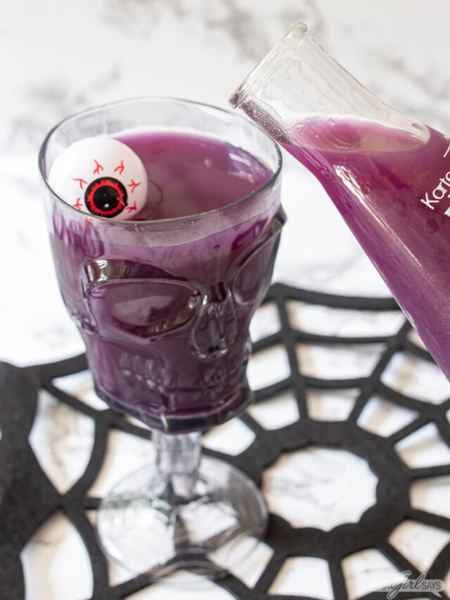 pouring Halloween punch into a skeleton goblet using a beaker