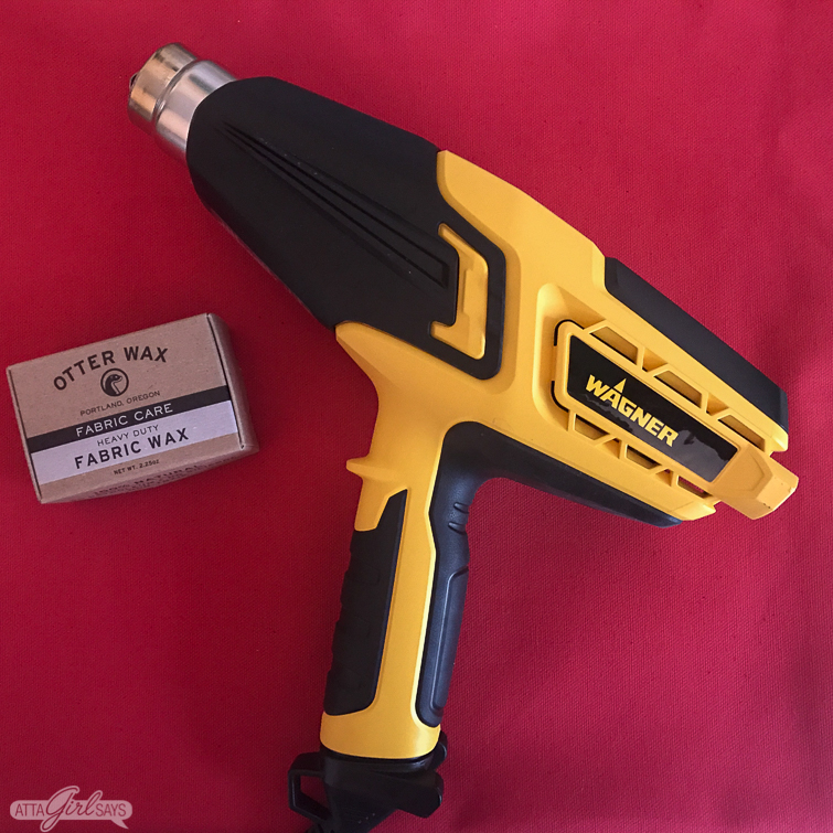 Wager heat gun and Otter fabric wax on top of red canvas