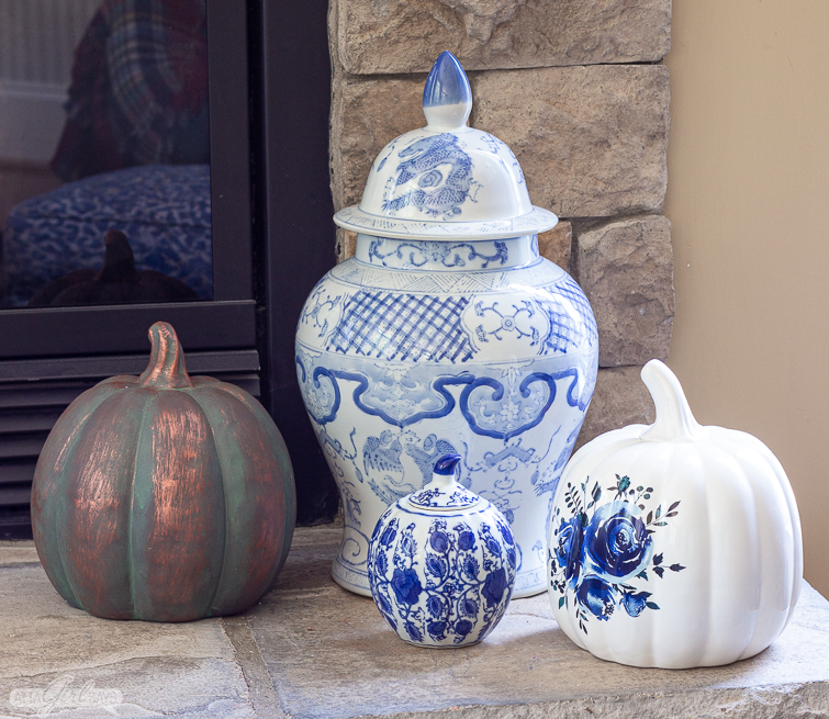 blue and white chinoiserie porcelain with copper and blue and white pumpkins on a stone hearth