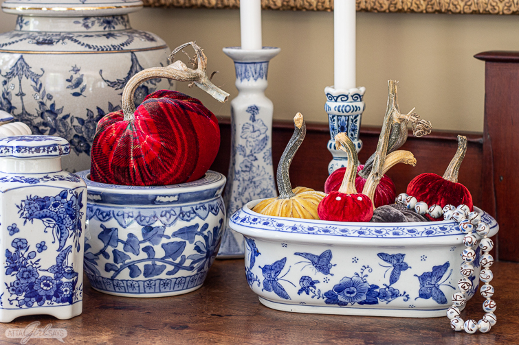 velvet pumpkins in blue and white chinoiserie on an antique empire sideboard