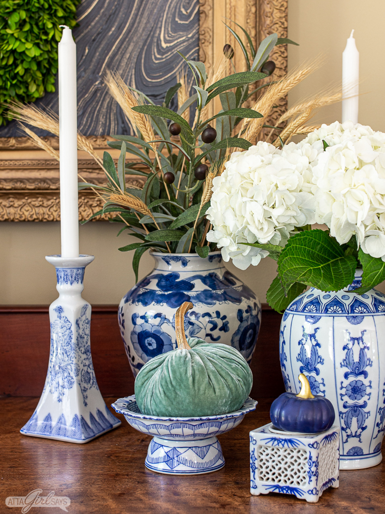 aqua velvet pumpkin on a pedestal alongside other blue and white chinoiserie pottery