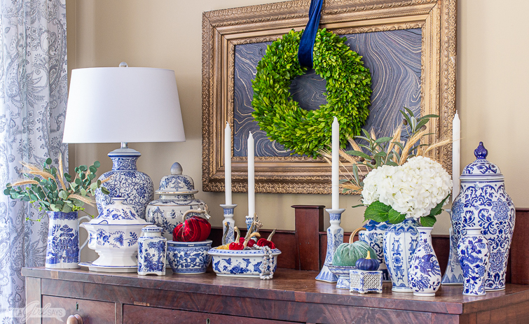 sideboard decorated with blue and white porcelain and velvet pumpkins for fall